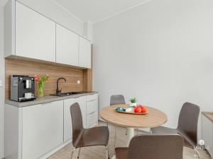 a kitchen with a table with a bowl of fruit on it at Apartment in Pobierowo near Baltic Beach in Pobierowo