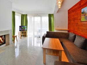 a living room with a couch and a table at Terraced House in Sarbinowo near the Beach in Sarbinowo