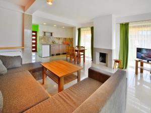a living room with a couch and a table at Terraced House in Sarbinowo near the Beach in Sarbinowo