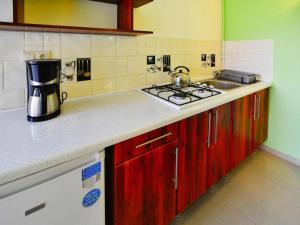 a kitchen counter with a sink and a stove at Holiday home with garden, close to the beach in Sarbinowo +18 photos