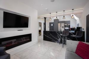 a living room with a fireplace and a flat screen tv at Luxury royal mile boutique 2bedroom apartment in Edinburgh