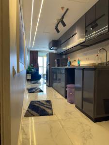 a kitchen with stainless steel cabinets and rugs on the floor at Amer Group Sokhna - عطلة أحلامك in Ain Sokhna
