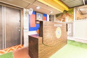 a reception desk in a room with a door at Hotel O Savitri Regency in Bhopal