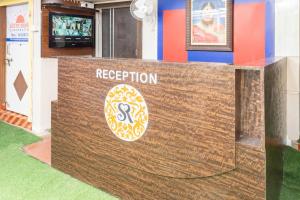 a reception sign in front of a building at Hotel O Savitri Regency in Bhopal