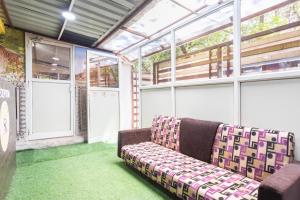 a couch sitting in a room with green carpet at Hotel O Savitri Regency in Bhopal