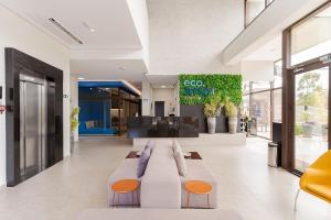 a living room with a couch and a lobby at Eco Smart - Ecoville | Gonzaga Stays in Curitiba