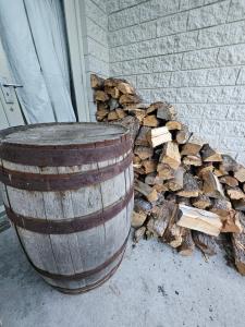 un tas de bois de chauffage à côté d'un tonneau dans l'établissement Friends & Family Groups gather, à Roxburgh