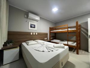 a bedroom with two bunk beds and a bed at Rosário Park Hotel in Rosário do Sul