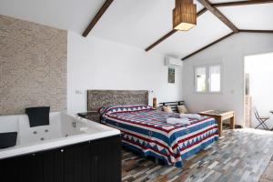 a bedroom with a bed and a bath tub at Villa Bali in Chiclana de la Frontera
