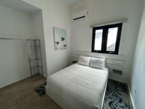 a white bedroom with a bed and a window at Elegant Home with KingBed Private Patio Ensuites in San Juan +80 photos