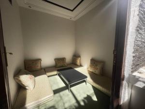 a small room with a table and two pillows at Relaxing stay in a quiet apartment in Laayoune +1 photo