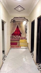 a living room with couches and a red curtain at Relaxing stay in a quiet apartment in Laayoune