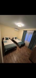 a room with two beds and a window at Souvenir in Isaccea