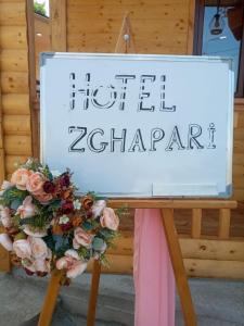 a sign for a hotel ziggurat with a bunch of flowers at Hotel Zghapari in Aspindza