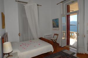 a bedroom with a bed and a sliding glass door at V. Molova, Molyvos, Lesvos in Mithymna