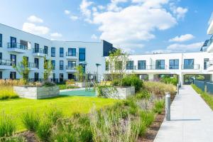 an apartment building with a courtyard with a playground at Nad Odra Gold Apartment in Szczecin
