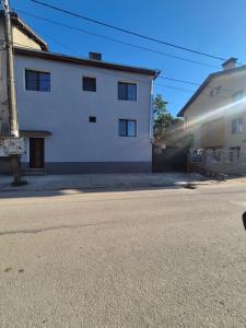 a white building on the side of a street at Guest House MARAVILA in Belogradchik +27 photos