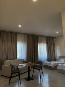 a living room with a couch and a bed and a table at Alashkert Hotel in Martuni