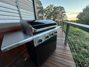 a grill on the deck of a house at The Oasis Retreat in Tomerong