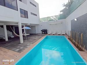a large swimming pool in a building with a house at Casa Moderna Completa c Alberca Climatizada 5 min Pirámides in San Juan Teotihuacán