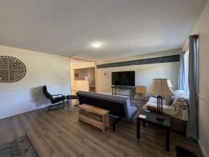 a living room with a couch and a bed at Wavesong Refuge in McKinleyville