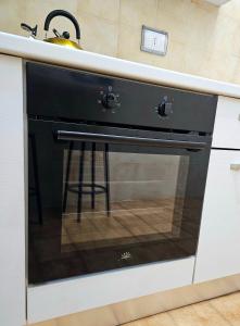 a black oven in a kitchen with a sink at Costantino Imperatore Apt in Rome