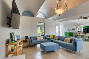 a living room with two blue couches and a table at Walk to Beach Unique Family Gem in Pass Christian in Long Beach