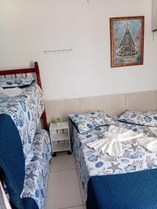 En eller flere senge i et værelse på Hospedagem Deus Conosco