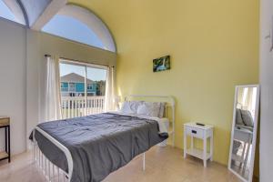 a bedroom with a bed and a large window at Walk to Beach Unique Family Gem in Pass Christian in Long Beach +32 photos