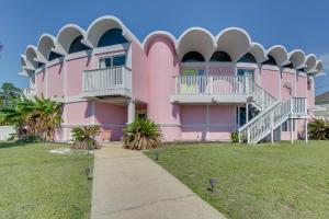 a pink building with a sidewalk in front of it at Walk to Beach Unique Family Gem in Pass Christian in Long Beach