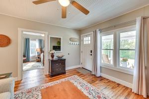 a living room with a ceiling fan and windows at Rock Climb, Hike, Relax! Quiet Beattyville Retreat in Beattyville