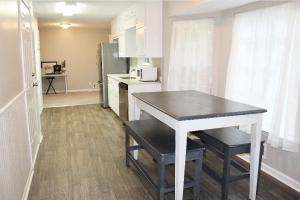 a small kitchen with a table and a counter top at The Stockbridge Hideaway in Stockbridge +4 photos