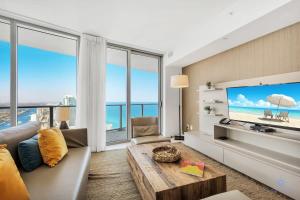 a living room with a large flat screen tv at Beautiful 1BR Apartment with Ocean View Balcony in Hollywood Beach