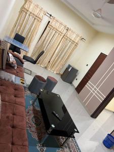 a living room with a couch and a flat screen tv at Résidence socorez in Ouagadougou