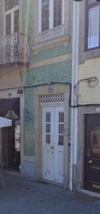 a building with a white door on a street at Pink Yellow Porto Apart in Porto +4 photos