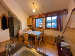 a kitchen with a table and chairs in a room at Fanningberg in Mariapfarr