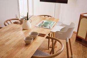 a wooden table with bowls and vases on it at Spacious 2BR Apartment near Subway Free Parking Seoul in Seoul