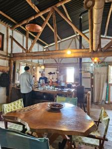 a man standing in a kitchen with a wooden table at Reserva Santa Lucia de Salento in Salento