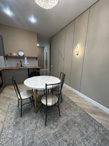 a dining room with a table and chairs at Perfect HoLiDaY in Almaty
