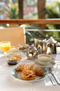 a table topped with a plate of pastries and orange juice at Hotel Villa Adriana in Monterosso al Mare