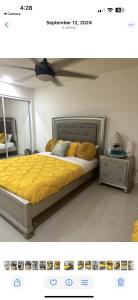 a bedroom with a bed with yellow sheets and pillows at Beautiful villa entire house in Plan Libertador