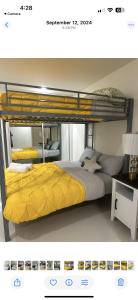a bedroom with a bunk bed with a yellow bedspread at Beautiful villa entire house in Plan Libertador