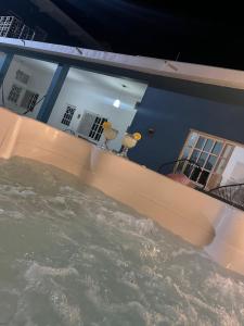 a pool of water in front of a house at Casa Punta Perula in Pérula