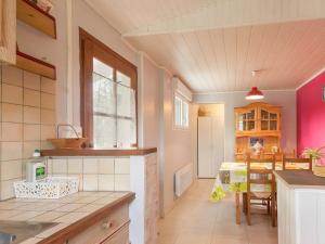 a kitchen with a table and a dining room at Gîte familial avec jardin clos, à proximité de Guérande et des plages, dans le Parc de Brière - FR-1-306-1070 in Crossac