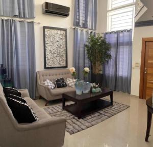 a living room with a couch and a coffee table at Hermosa Casa familiar en las orquideas LR in La Romana