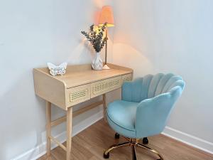 a desk with a blue chair and a desk with a lamp at Bee Happy Sparta Mountain Cottage in Sparta