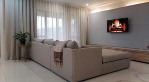 a living room with a couch and a window at The Hide Nongoma in Nongoma +8 photos