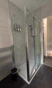 a shower with a glass door in a bathroom at Modern 2Bedroom House in Coventry Private Parking in Coventry +34 photos