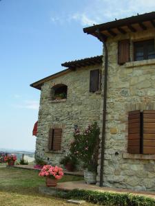 カストロカーロ・テルメにあるAgriturismo Monte Valbelleの花の前の石造りの家