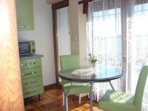 a dining room with a glass table and a window at Apartments Špiko in Hvar